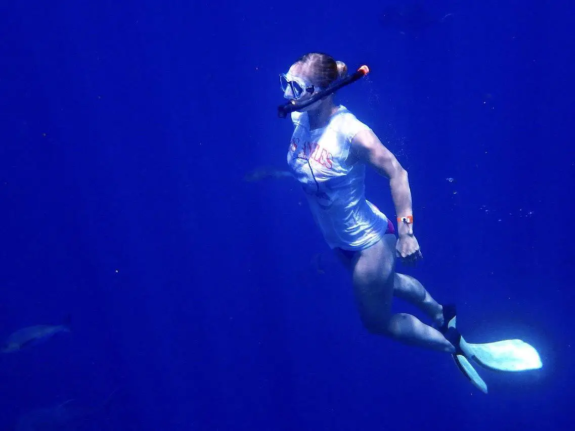 Free diving, covering more ground, saving energy, and being able to handle currents are some of the benefits of fins, as this female free diver shows